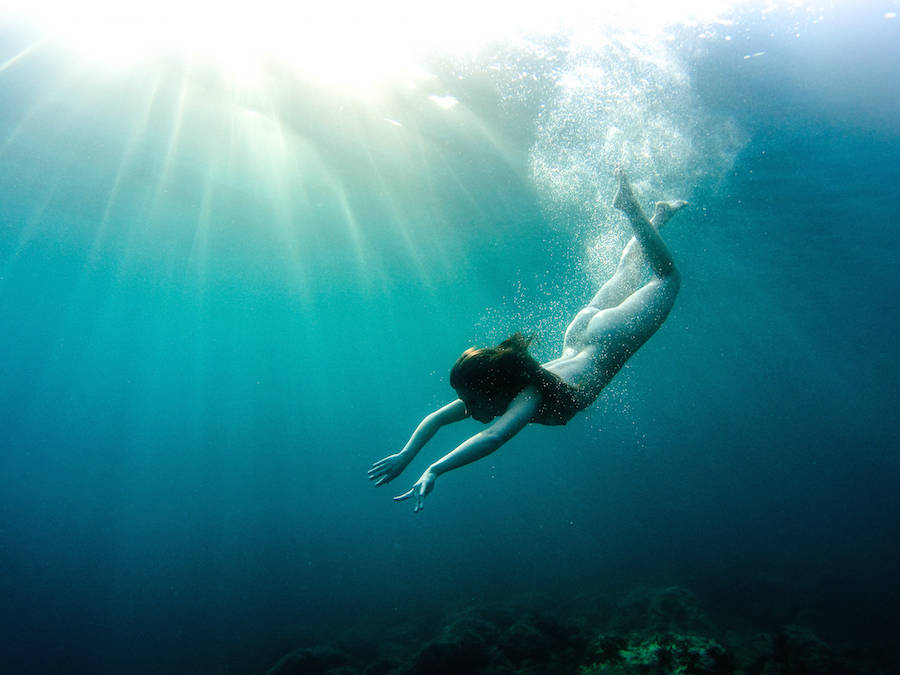 Nude underwater scuba diving