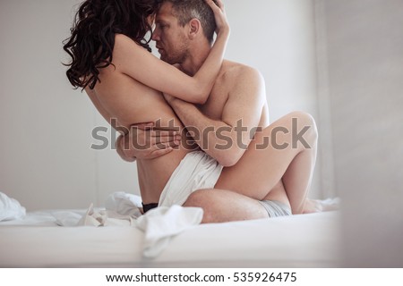 Couple having sex on bed