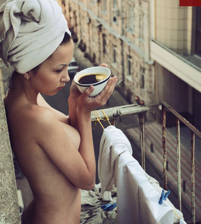 Nude woman with coffee cup